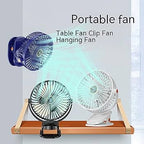 Small portable clip fan attached to desk providing cooling airflow for office workspace