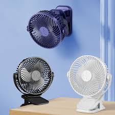 Rechargeable mini fan with clip used outdoors for travel camping and summer cooling